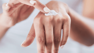 Person applying Flexitol hand balm