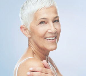 Image of woman holding her shoulder and looking to her side