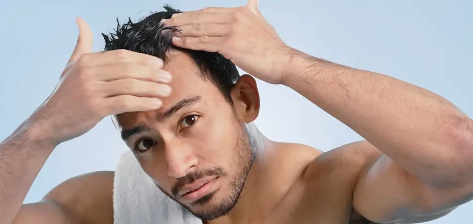 A man looking at his scalp thinking about using Flexitol Scalp Relief Shampoo & Conditioner