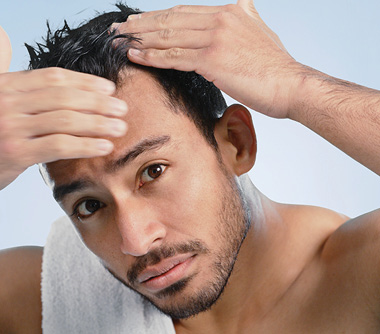 A man looking at his scalp