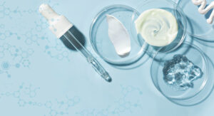 Promotional graphic on a light blue background with molecule chains and laboratory dishes with swashes of gel, cream and lotion