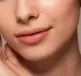Close up of woman's lips wearing Manuka Lip Balm