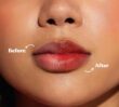 Close-up of lips showing before and after application of cherry red tinted lip balm with visible color difference