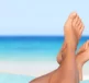 A person with their feet up, relaxing on a beach - wondering what Urea Percentage Is Right for Diabetic Skin?